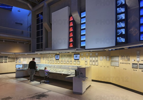 Father with his two small children in the huge energy hall of DASA, German Occupational Safety Exhibition, Dortmund, Germany