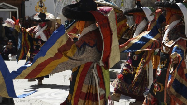 People wearing traditional garments dancing in festive community, Leh, trekking in Ladakh, Himalayas, India
