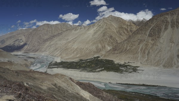 Extensive Nubra Valley with river course and impressive mountains under sunny skies, trekking in Ladakh, Himalayas, India