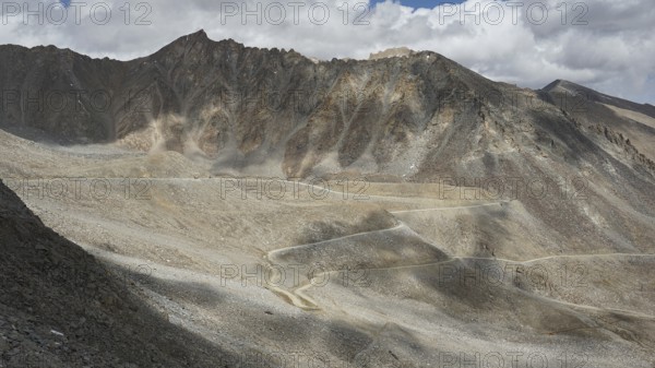 Close view of a winding road through a rocky mountain landscape, trekking in Ladakh, Himalayas, India