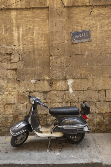 Cairo, Egypt. July 7th 2024 A grey coloured scooter parked in the narrow alley ways of the historical quarter of Islamic Cairo, a popular mode of transport in the busy city. Egypt