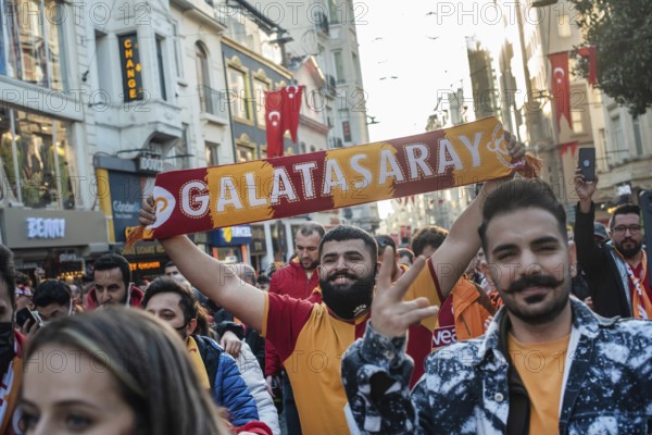 Istanbul, Turkey. November 11th 2021 A smiling Turkish Galatasary football fan holding a supporters scarf on the way to a game in Istanbul, Turkey