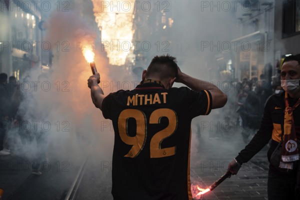 Istanbul, Turkey. November 21st 2021 Turkish Galatasary football supporters light flares in Taksim square on their way to the derby game with rivals Fenerbahce, Istanbul, Turkey