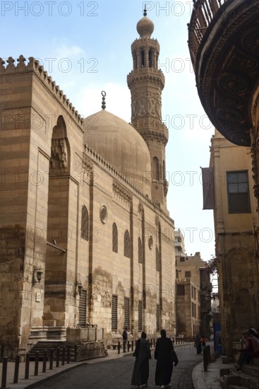 Cairo, Egypt. July 7th 2024 Locals and tourists walk past one of the many restored monuments along Sharia Al Muizz Li Din Allah near Khan El Khalili Bazaar, historical Cairo, Egypt