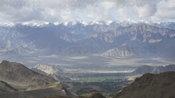 Majestic mountains with snowy peaks under a cloudy sky, Nubra Valley, trekking in Ladakh, Himalayas, India