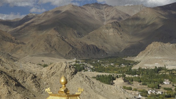 View of a valley with Buddhist buildings and surrounding mountains, trekking in Ladakh, Himalayas, India