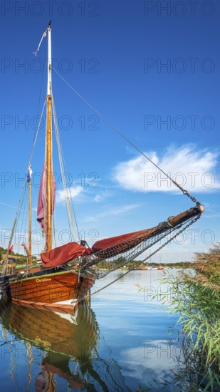 Traditional wooden sailboat in the harbor on the ferry of Moritzdorf, OT of Sellin, Mönchgut peninsula, Rügen island, Mecklenburg-Western Pomerania, Germany