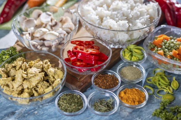 Various fresh ingredients such as peppers, carrots, rice and spices