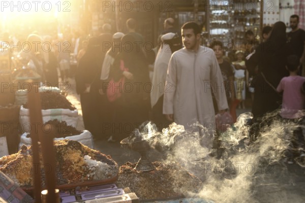 Cairo, Egypt. July 2nd 2024 Smoke from burning incense in a busy market in the historical Islamic quarter of Cairo, Egypt