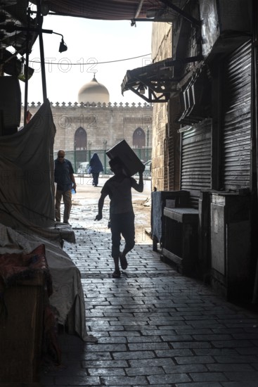 Cairo, Egypt. July 1st 2024 Workers in the narrow cobbled alley ways of Islamic Cairo near the famous Khan el Khalili Bazaar, a popular shopping and trading district of the Egyptian capital, Egypt