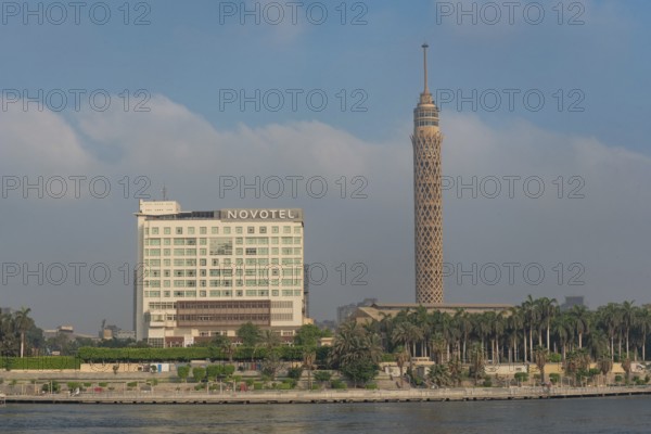 Cairo, Egypt. July 1st 2024 The Cairo Tower and Novotel in El Gezira Street, Zamalek, Cairo, beside Kasr El Nil Bridge over the River Nile, Egypt