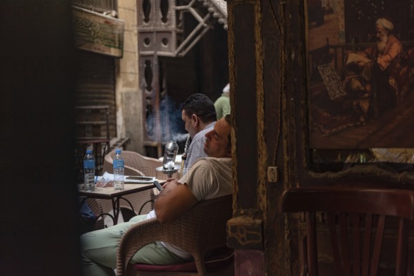 Cairo, Egypt. June 24th 2024 An Egyptian man sleeps in a Downtown Cairo coffee shop during the exceptionally hot weather of summer in Egypt