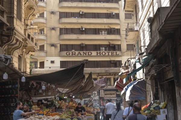 Cairo, Egypt. June 14th 2024 The art-deco Grand Hotel building in Al Azbakeya, Downtown Cairo seen from Souk Al Tawfik a popular fruit and vegetable market, Egypt