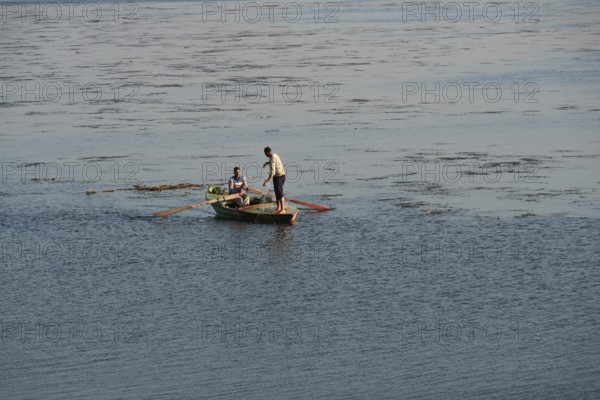 Al Qanatir Al Khayriyyah, Egypt. December 18th 2022 Fishermen on a small boat on the Nile River nr the Delta Barrage where the Nile splits into two branches. Egypt
