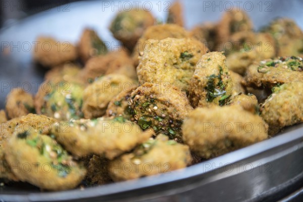 A close up detail of freshly cooked deep fried Falafel, a chickpea and herb filled snack popular in Egypt and all over the Middle East