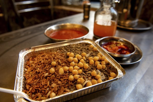 Koshary, kushari or koshari the most popular culinary dish in Egypt, a mix of pasta, rice, lentils, chickpeas and fried onions and topped with tomato and garlic sauce