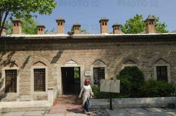 Bursa, Turkey. April 21st 2014 A Turkish Muslim woman walks from the exit of the Koza Han in the city of Bursa, Turkey