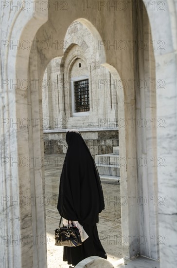 Bursa, Turkey. April 21st 2014 A Muslim women visiting the Grand Mosque of Bursa city in Turkey