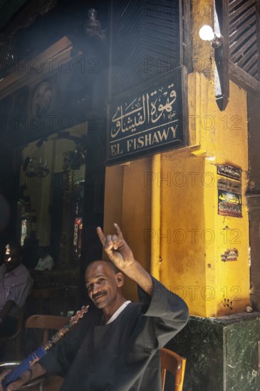 Cairo, Egypt. July 23rd 2011 An Egyptian man enjoying a shisha water pipe in the famous El Fishawy cafe, Khan el Khalili Bazaar, Cairo, Egypt