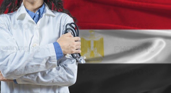 Healthcare professional with Egypt flag background. Professional doctor holding stethoscope on Egypt flag background