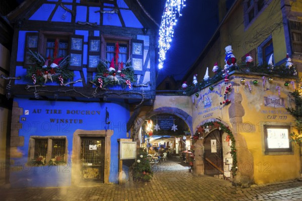Colour-illuminated and Christmassy decorated half-timbered houses, blue hour, Christmas market, Riquewihr, Grand Est, Haut-Rhin, Alsace, France