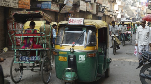 Busy street in India with rickshaws and people, dynamic city scene, Delhi