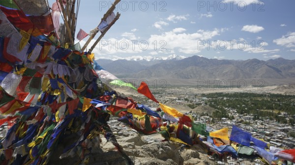 Colourful prayer flags flutter high above a vast mountain landscape, Ladakh, North India, Himalayas, India