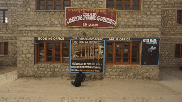 Ladakh bus operator cooperative stone building with signs and street view, Leh, Ladakh, North India, Himalayas, India