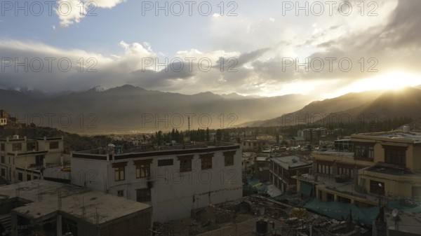 Leh in the evening light with mountains in the background and clouds covering the horizon, Ladakh, North India, Himalayas, India