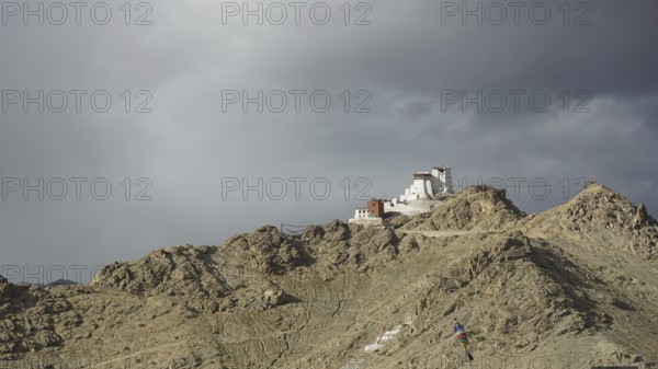 Monastery on rocky hill under dramatic sky near Leh, Ladakh, northern India, Himalayas, India