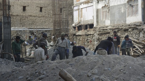 Workers on a construction site in Leh working on a building in harsh conditions, Ladakh, North India, Himalayas, India