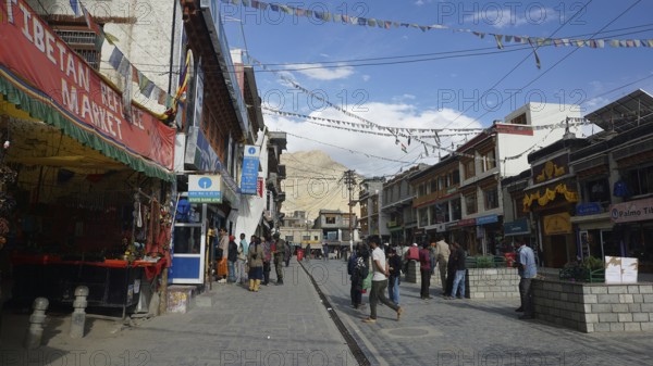 Busy street in Leh with traditional shops and flying prayer flags, Ladakh, North India, Himalayas, India
