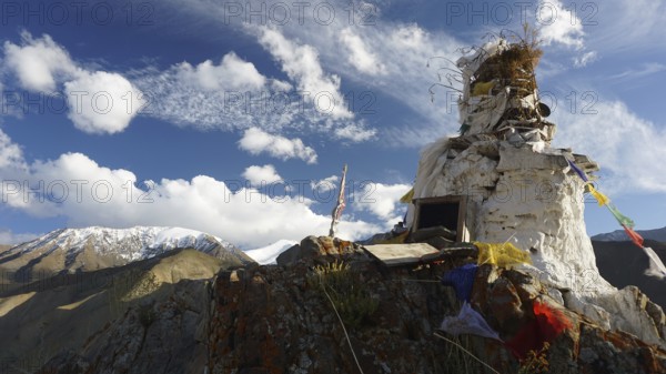 A white Buddhist site on a mountain top, trekking to Stok la Pass with clear blue sky backdrop, Ladakh, Himalayas, India