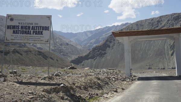 Entrance gate to Hemis National Park with sign and mountainous surroundings, Ladakh, Himalayas, India