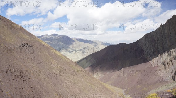 Mountain landscape with soft colors under a partly cloudy sky, trekking at Stok La Pass in Ladakh, Himalayas, India