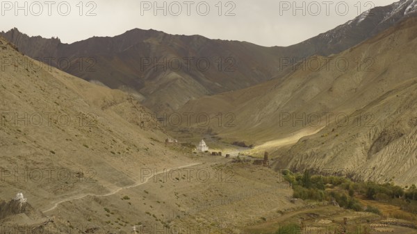 Wide valley with a trail in the midst of a majestic mountainous landscape, trekking in Ladakh, Himalayas, India