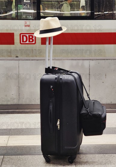 Luggage left alone with hat on platform in front of Intercity Express ICE, Berlin Central Station, Germany