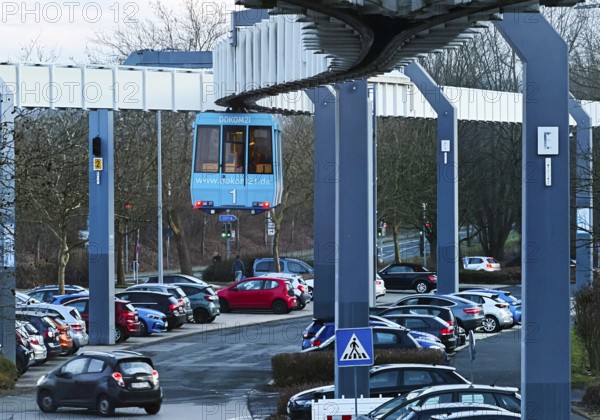 The H Bahn, an automatically controlled large cabin suspension railway above the parking lot of the university campus, Dortmund, Germany