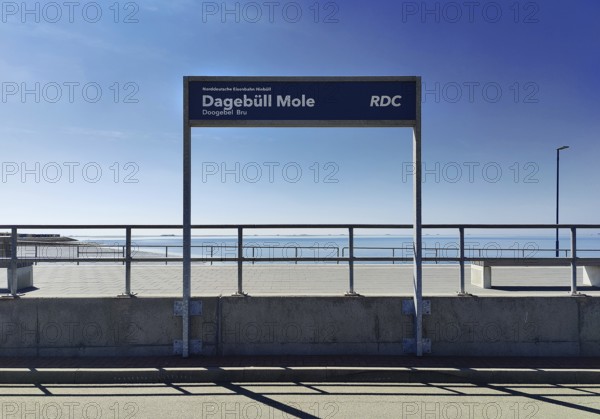 Dagebüll Mole sign of the Norddeutsche Eisenbahn Niebüll with a view of the North Sea, Schleswig-Holstein, Germany