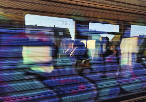 View from the window and reflection on a moving regional train, Germany