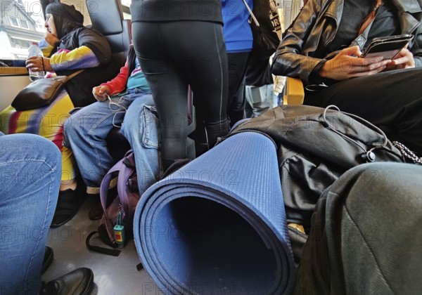 Many people crowded with their luggage on a very busy regional train, Germany
