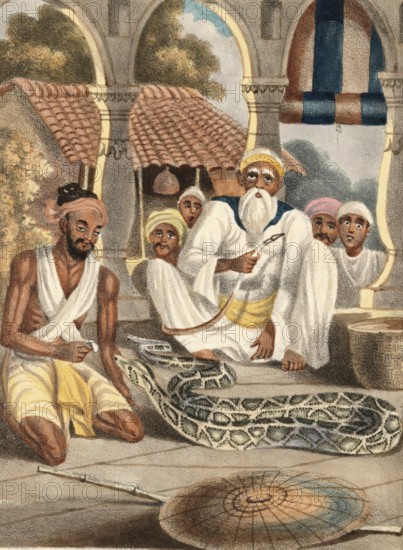 A samporea or snake catcher in India, authentic, digitally restored reproduction from a 19th-century model, exact date of depiction unknown, historical, elderly men sitting in an archway with a snake in a basket