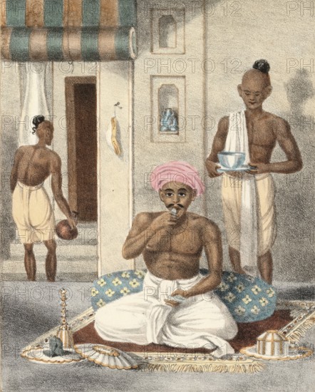 A high-ranking Hindu man eating a shrimp, India, authentic, digitally restored reproduction from a 19th century original, exact date of depiction unknown, historical, men in the interior, one drinks tea in a relaxed atmosphere