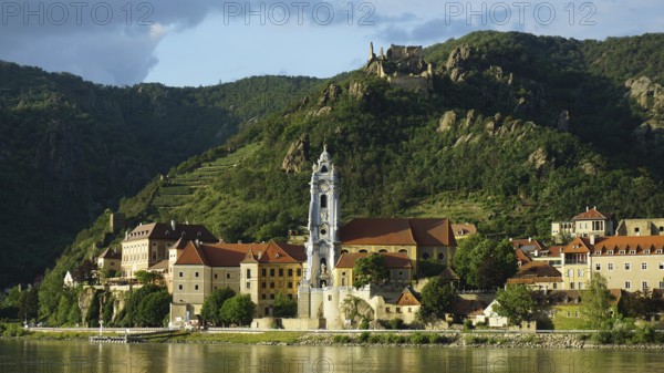 Evening light over Dürnstein with dramatic landscape and river, Danube cycle path, Wachau World Heritage Region, Austria