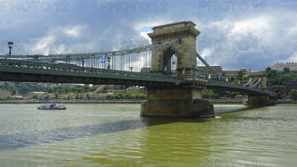 The Szechenyi Chain Bridge across the Danube under a cloudy sky, connection between Buda and Pest, Budapest, Hungary