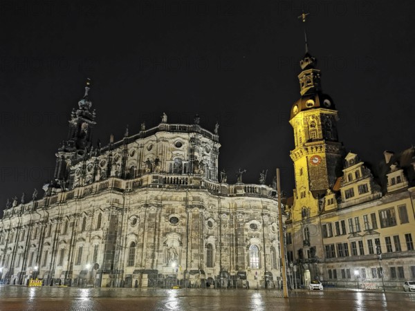 Night view of an illuminated cathedral and a distinctive tower with historic flair in the historic old town of Dresden