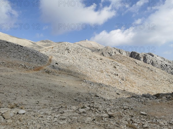 Rocky mountain landscape on Tahtali Dagi, peaks in sight, under a partly cloudy sky, climbing Tahtali Dagi, Lycia, Turkey