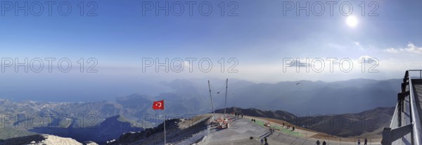 Panorama at the summit of Tahtali Dagi, extensive mountain landscape with a Turkish flag and clear sky, ascent of Tahtali Dagi, Lycia, Turkey