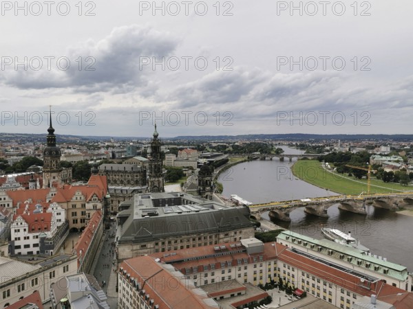 View of Dresden on the Elbe with bridge and historic buildings under cloudy sky, Dresden