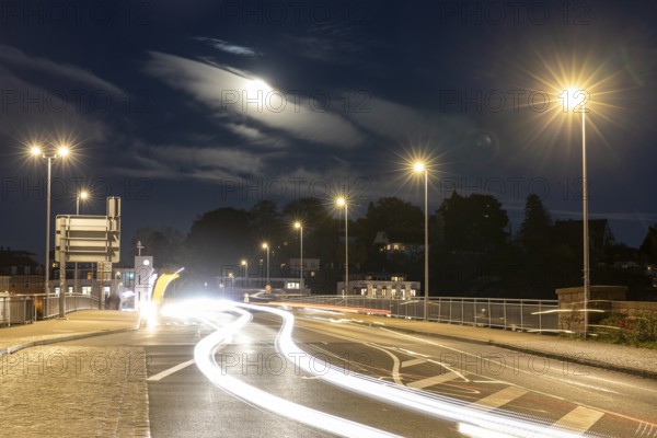 Night scene at the old Elbe bridge with traffic, lanterns and full moon, Meissen, Saxony, Germany